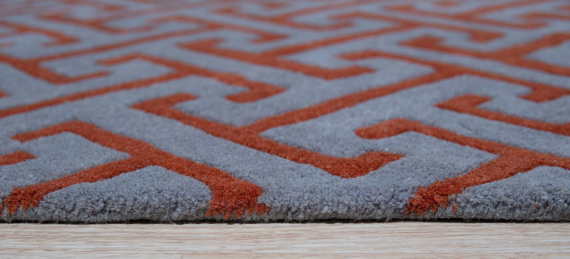 Comfortable Celia Gray Hand Tufted Wool Rug, featuring a subtly textured gray field, lending a soft, luxurious feel to a well-lit interior.