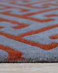 Comfortable Celia Gray Hand Tufted Wool Rug, featuring a subtly textured gray field, lending a soft, luxurious feel to a well-lit interior.