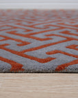 Comfortable Celia Gray Hand Tufted Wool Rug, its soft gray hues and hand-tufted texture adding warmth to a bright, modern living room with light hardwood floors and neutral furniture.