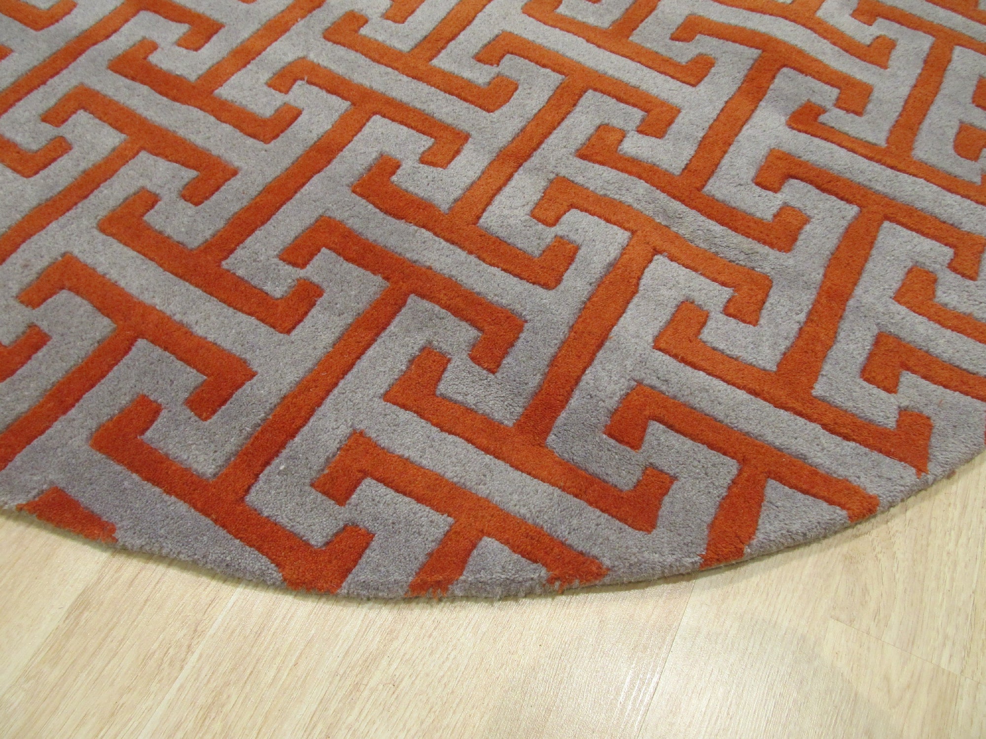 Comfortable Celia Gray Hand Tufted Wool Rug, its textured gray surface and subtle pattern complementing a light-filled, modern living room.