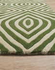 Zinnia Amara Green Hand Tufted Wool Rug displayed, its textured green wool pile a captivating blend of depth and comfort within a softly lit interior.