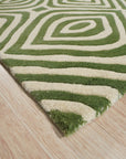 Zinnia Amara Green Hand Tufted Wool Rug, showcasing its textured, botanical design with varying shades of green, bringing a touch of organic elegance to a modern living space.