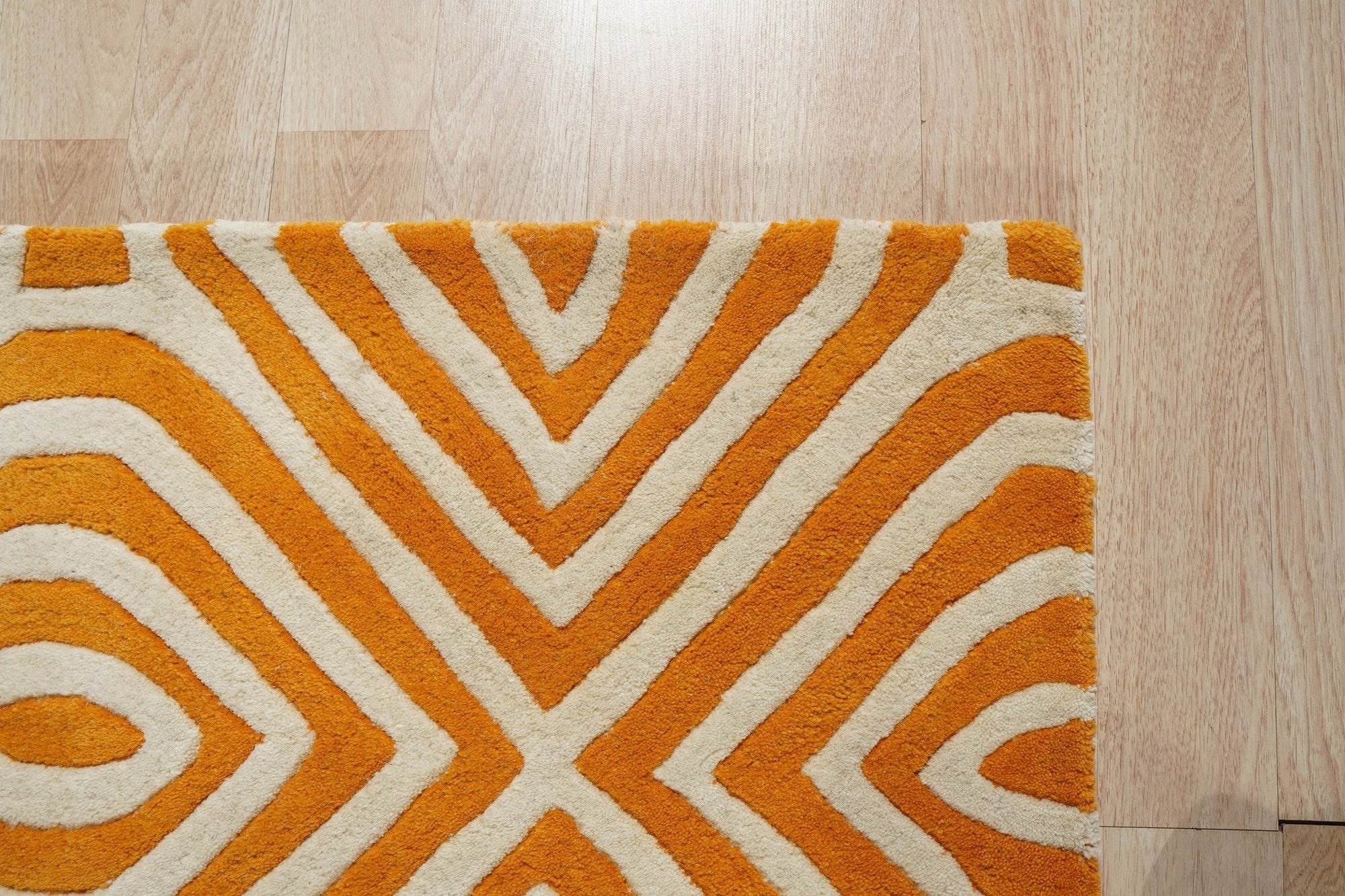 Sophisticated Jade Light Orange Hand Tufted Wool Rug, showing a blend of soft jade and light orange hues in a textured, hand-tufted construction, displayed within a room setting.
