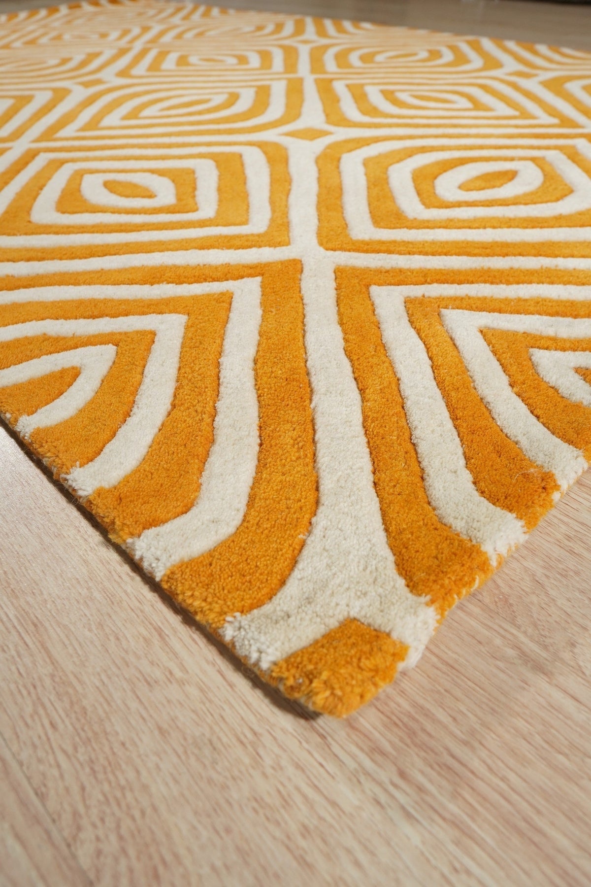 Sophisticated Jade Light Orange Hand Tufted Wool Rug, displaying a blend of jade and light orange hues, complements a modern interior with neutral walls and furniture, highlighting its soft wool construction and hand-tufted detail.