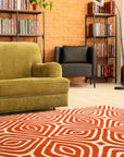 Luxurious Warm Orange Hand Tufted Wool Rug, rich orange pile invitingly textured, partially visible suggesting a cozy and stylish interior.