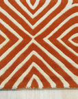 Luxurious Warm Orange Hand Tufted Wool Rug, its rich orange tones and plush, hand-tufted texture anchoring a modern living room with light wood flooring and neutral furniture.