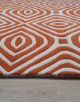 Luxurious Warm Orange Hand Tufted Wool Rug, its vibrant orange hues and plush wool texture adding warmth to a softly lit room.