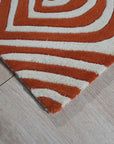 Luxurious Warm Orange Hand Tufted Wool Rug, vibrant and inviting, anchors a living space with its rich orange hue and plush texture. Hand tufted wool construction creates a dense, comfortable pile. Seen in a modern setting, complements neutral furniture with warmth and sophistication.