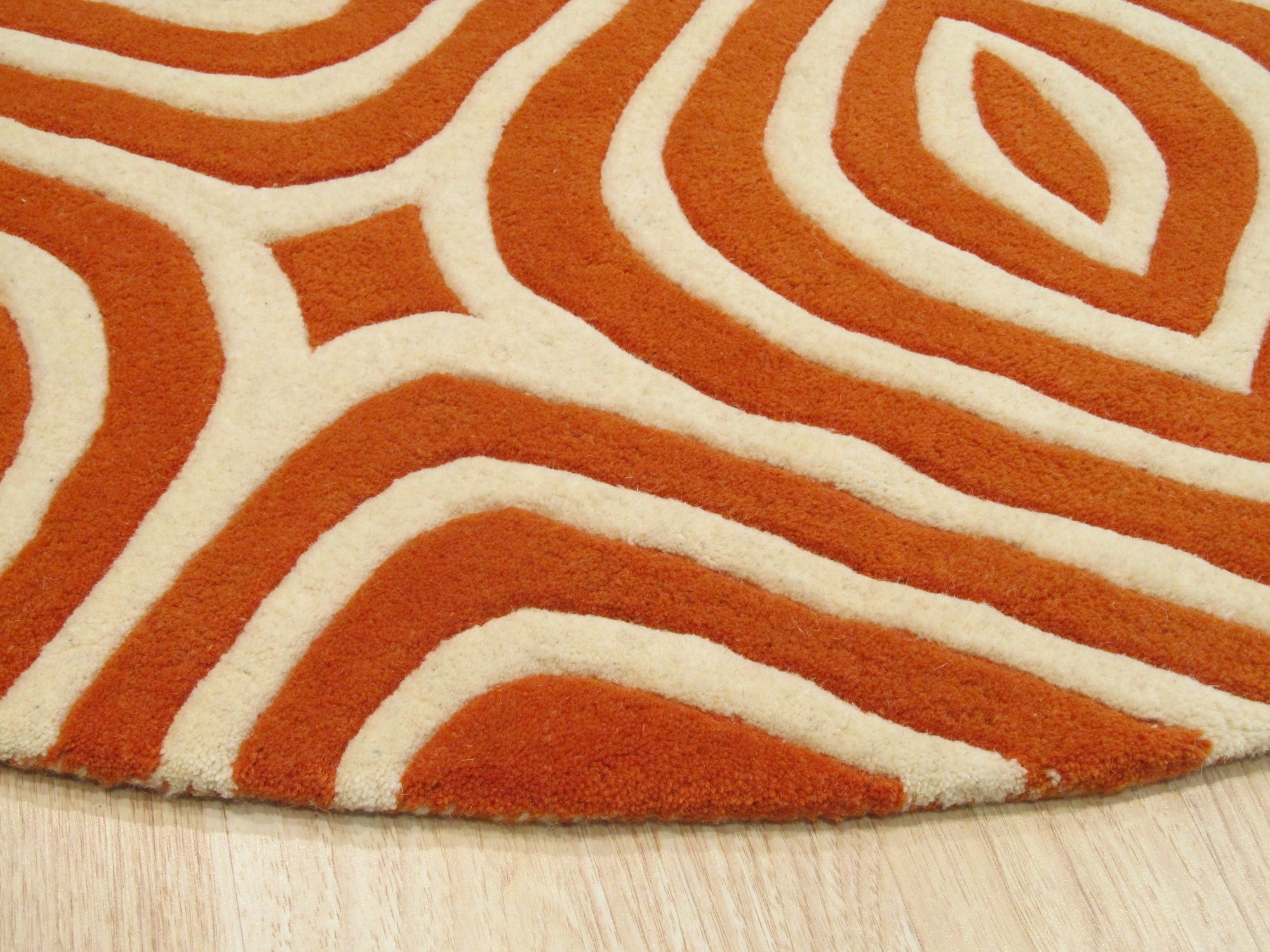 Luxurious Warm Orange Hand Tufted Wool Rug, its dense pile radiating warmth and texture, seen enhancing a bright, modern living space.
