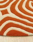 Luxurious Warm Orange Hand Tufted Wool Rug, its dense pile radiating warmth and texture, seen enhancing a bright, modern living space.
