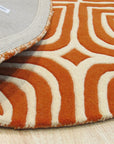 Luxurious Warm Orange Hand Tufted Wool Rug, its plush pile casting a warm glow on a hardwood floor, showcasing the intricate hand-tufted construction and vibrant orange hue.
