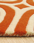 Luxurious Warm Orange Hand Tufted Wool Rug, its plush, hand-tufted wool fibers radiating a rich, warm orange hue, displayed against a neutral backdrop highlighting its texture and color depth.