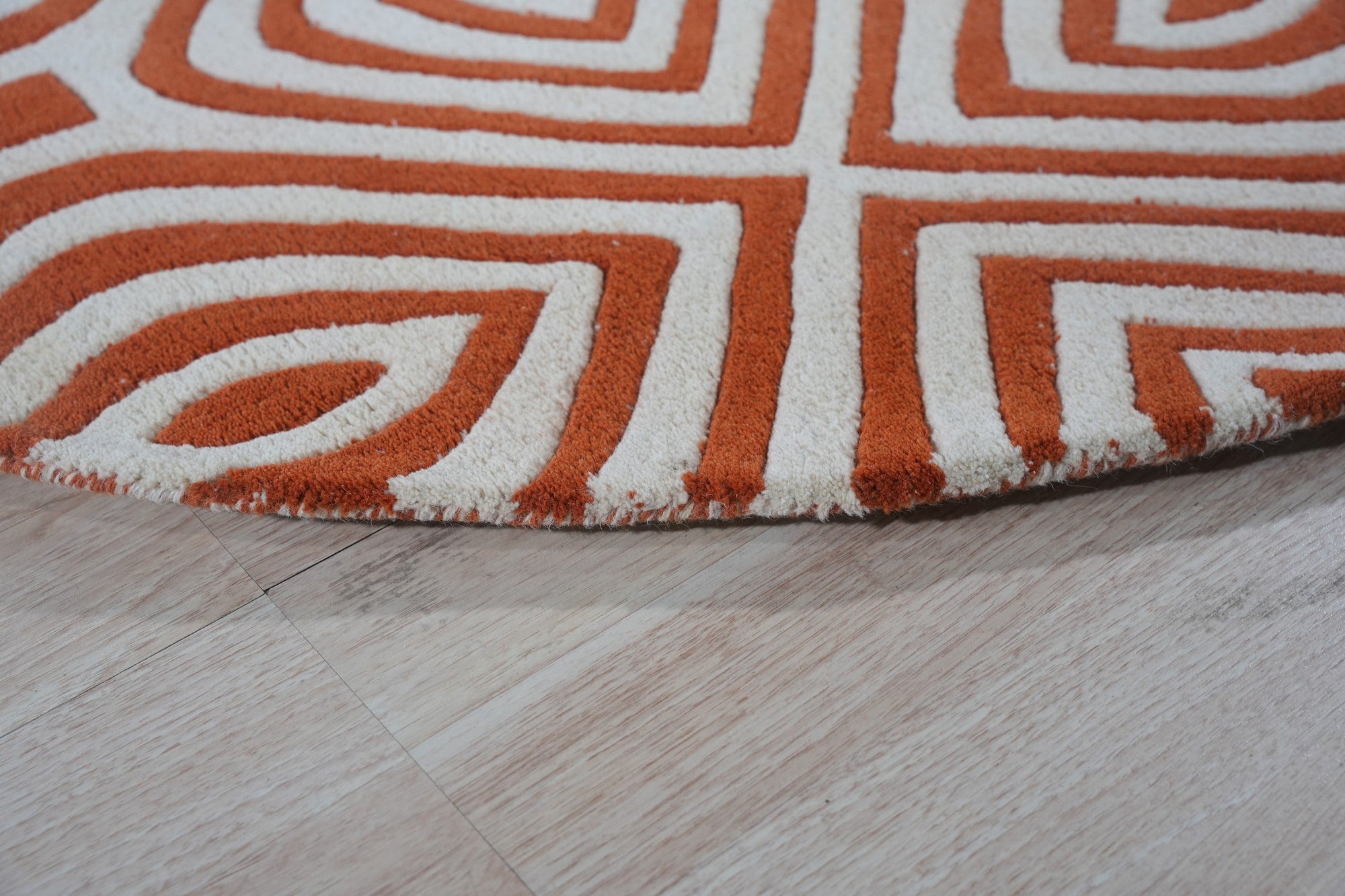 Luxurious Warm Orange Hand Tufted Wool Rug, a vibrant orange wool rug with a plush, hand-tufted texture, filling the frame with its inviting warmth.