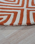 Luxurious Warm Orange Hand Tufted Wool Rug, a vibrant orange wool rug with a plush, hand-tufted texture, filling the frame with its inviting warmth.
