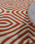 Luxurious Warm Orange Hand Tufted Wool Rug, its plush orange pile radiating warmth in a bright, airy living space.