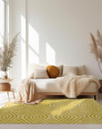 Ruby Para Yellow Hand Tufted Wool Rug, showcasing a vibrant yellow and ruby pattern, lies on a light hardwood floor, its dense wool pile adding warmth and texture to the bright, airy room.