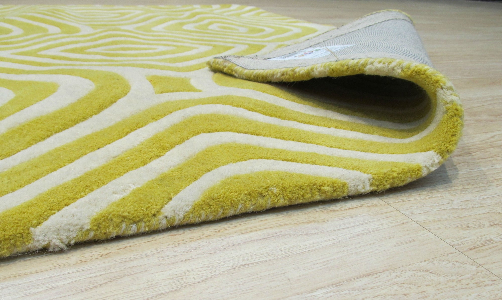 Ruby Para Yellow Hand Tufted Wool Rug, blending vibrant ruby and sunny yellow in a hand-tufted design, rests invitingly in a brightly lit interior.