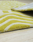 Ruby Para Yellow Hand Tufted Wool Rug, blending vibrant ruby and sunny yellow in a hand-tufted design, rests invitingly in a brightly lit interior.