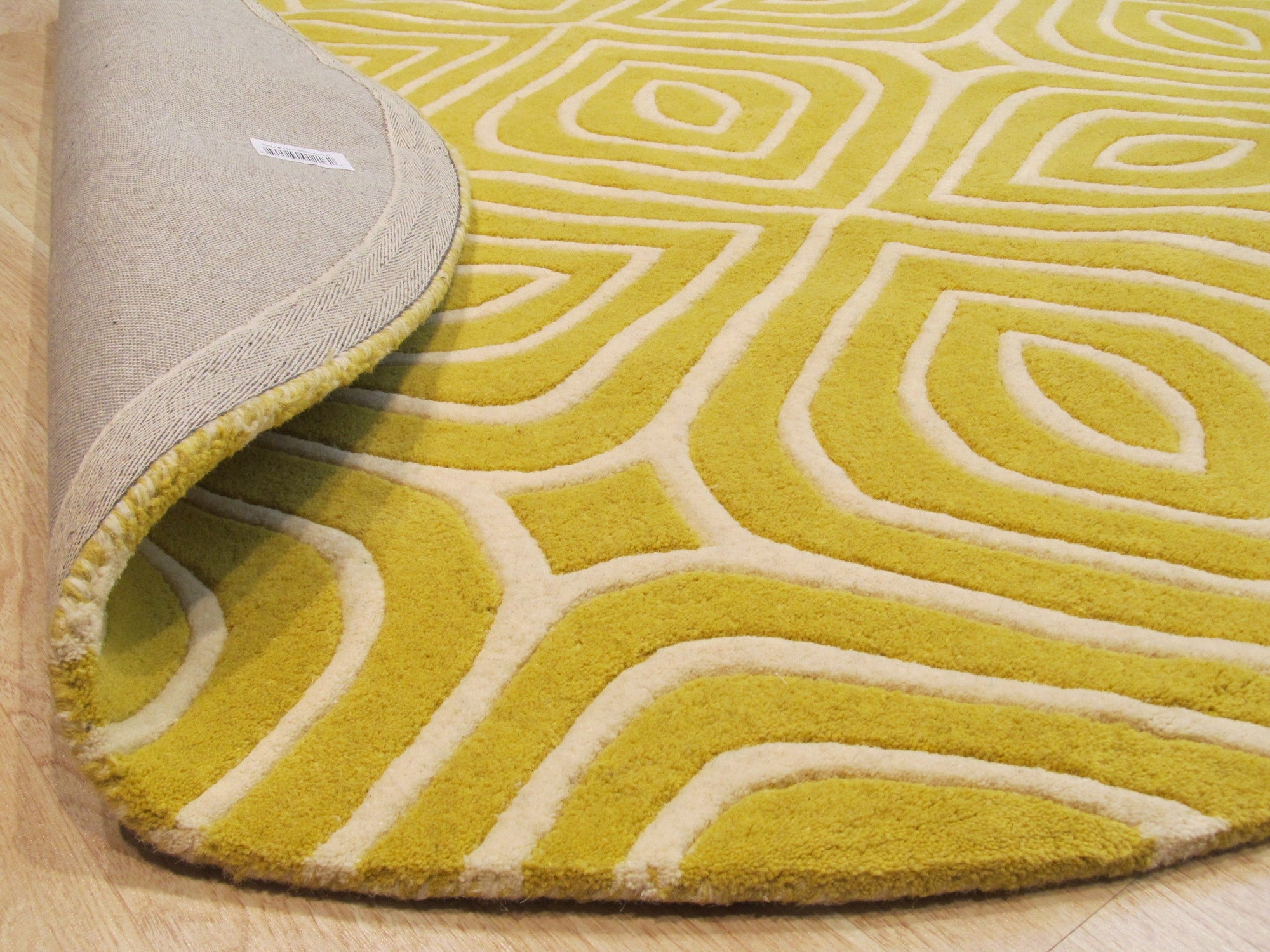 Ruby Para Yellow Hand Tufted Wool Rug, a vibrant yellow and ruby-toned wool rug with a bold, abstract design, showcased in a bright, modern living room setting.