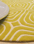 Ruby Para Yellow Hand Tufted Wool Rug, a vibrant yellow and ruby-toned wool rug with a bold, abstract design, showcased in a bright, modern living room setting.