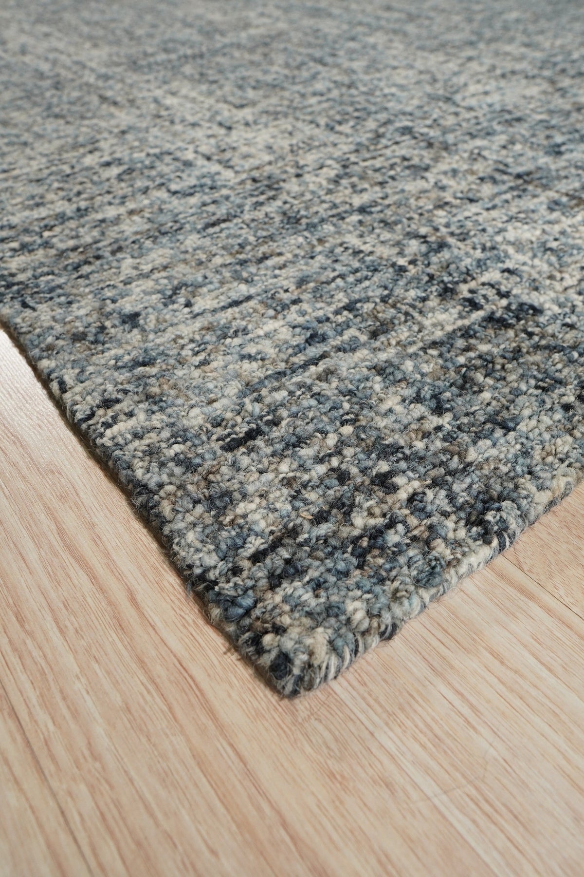 Elena Modern Dark Blue Hand Tufted Wool Rug, a luxurious dark blue wool rug with a modern design, displayed in a well-lit living room setting.