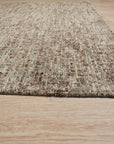 Kira Selene Dark Brown Hand Tufted Wool Rug graces a warmly lit living space, its deep brown tones anchoring a modern setting.