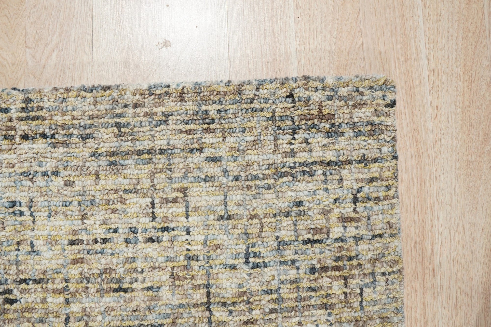 Kira Selene Dark Brown Hand Tufted Wool Rug, its deep brown tones and plush texture grounding a modern living room with a cream sofa and natural light.