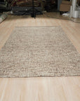 Kira Selene Dark Brown Hand Tufted Wool Rug, displaying its intricate texture and rich, dark brown hue in a styled room setting.
