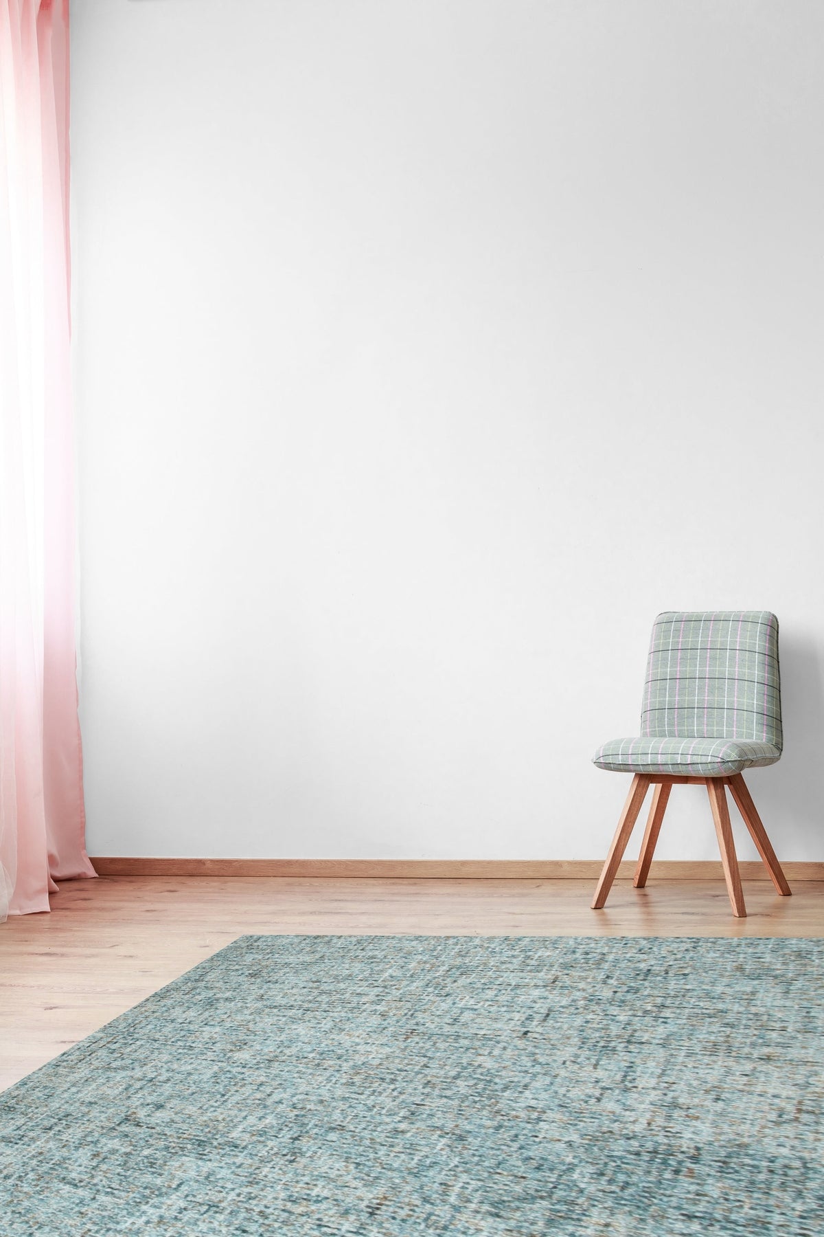 Artisan Stylish Light Green Hand Tufted Wool Rug gracing a bright, modern living room. Light washes across its soft, hand-tufted texture, highlighting subtle variations within the light green wool. Contemporary furniture complements the rug's understated elegance.
