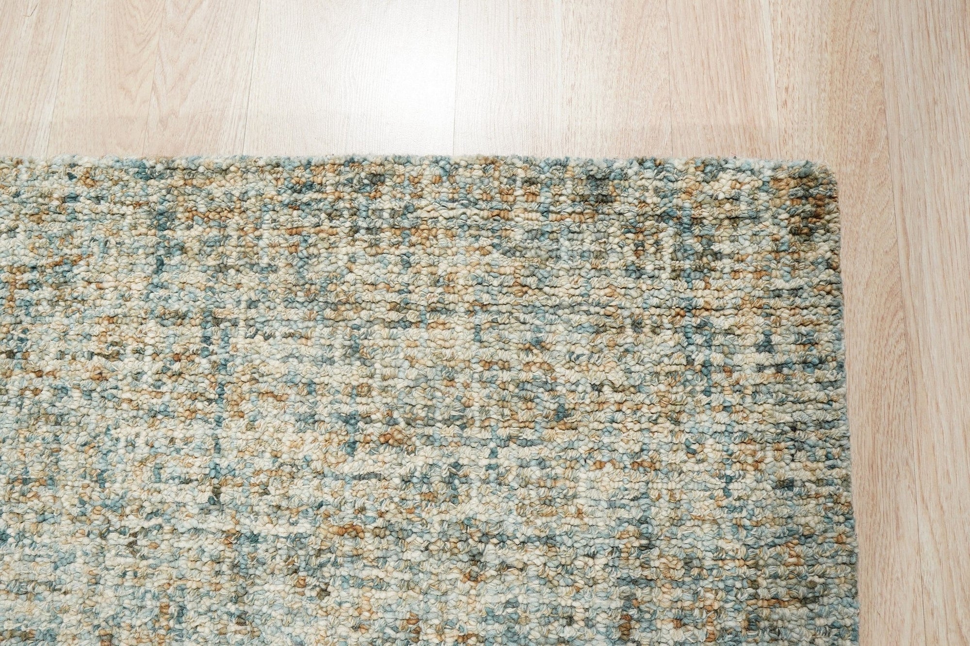 Artisan Stylish Light Green Hand Tufted Wool Rug, light green hand-tufted wool creates inviting texture under a modern, minimalist side table with a warm lamp glow softly illuminating the rug's subtle design variations.