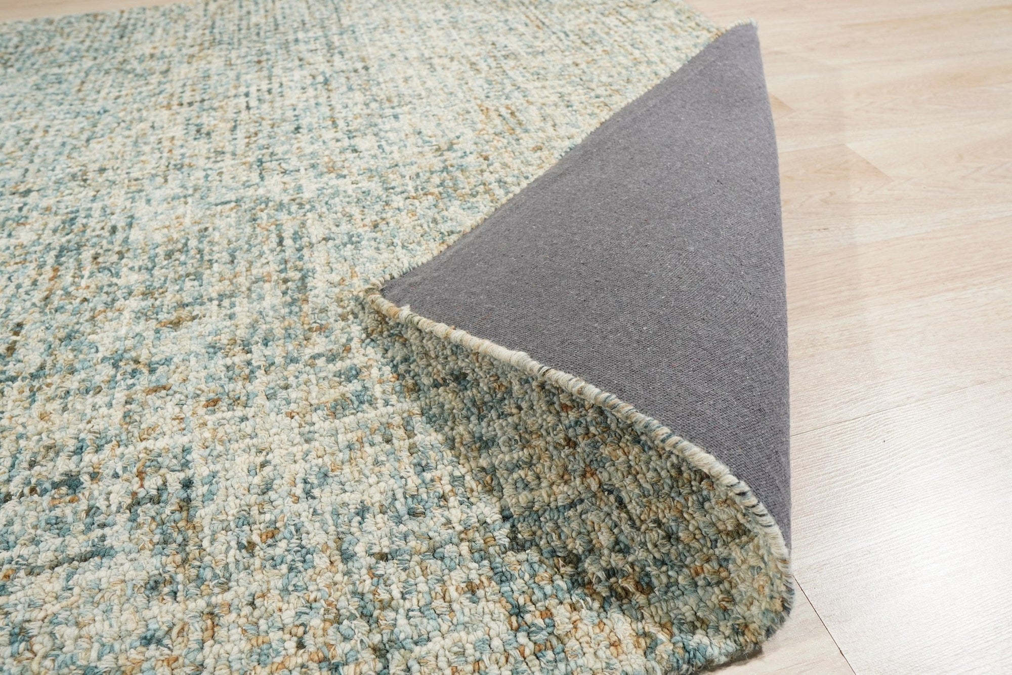 Artisan Stylish Light Green Hand Tufted Wool Rug, a light green wool rug featuring a subtly textured hand-tufted design, seen in a bright room setting.