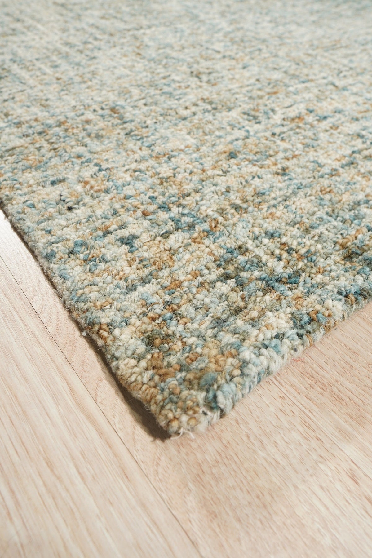 Artisan Stylish Light Green Hand Tufted Wool Rug, a calming light green hand-tufted wool rug, softens a modern living room with its plush texture and subtle design, complemented by warm lighting and neutral furniture.