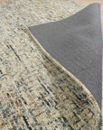 Maya Bianca Navy Hand Tufted Wool Rug, showcasing a textured, modern design with intricate patterns in deep navy and contrasting ivory hues, laid out on a light hardwood floor with natural light.