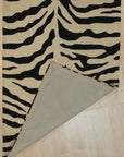Cassandra Elegant Black Hand Tufted Wool Rug, its plush black wool pile inviting touch, showcased in a modern living room setting.