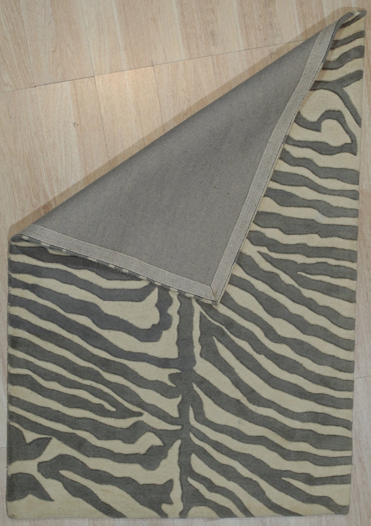 Penelope Stylish Gray Hand Tufted Wool Rug, its soft gray tones and plush hand-tufted texture inviting touch, anchors a living room space with modern elegance.