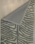 Penelope Stylish Gray Hand Tufted Wool Rug, its soft gray tones and plush hand-tufted texture inviting touch, anchors a living room space with modern elegance.