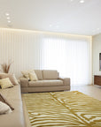 Dahlia Sleek Gold Hand Tufted Wool Rug, its subtle gold tones and soft wool texture complementing a modern living room with neutral furniture.
