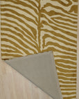 Dahlia Sleek Gold Hand Tufted Wool Rug, luxurious gold accents gleam against a plush wool backdrop, hand-tufted artistry adding depth and texture, seen in a bright, contemporary living space.