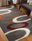 Celia Clara Gray Hand Tufted Wool Rug displayed in a living room setting, grounding a seating area with soft grays and subtle patterns.