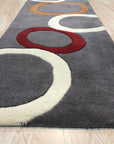 Celia Clara Gray Hand Tufted Wool Rug, a soft gray wool rug with a subtle, textured design, lying on a polished hardwood floor.