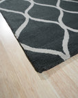 Beautiful Luna Black Hand Tufted Wool Rug, its textured black wool pile adding depth to a contemporary living room setting with neutral furniture.