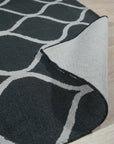 Beautiful Luna Black Hand Tufted Wool Rug, a modern statement piece under a sleek black coffee table, its textured wool contrasting with the smooth metal legs.