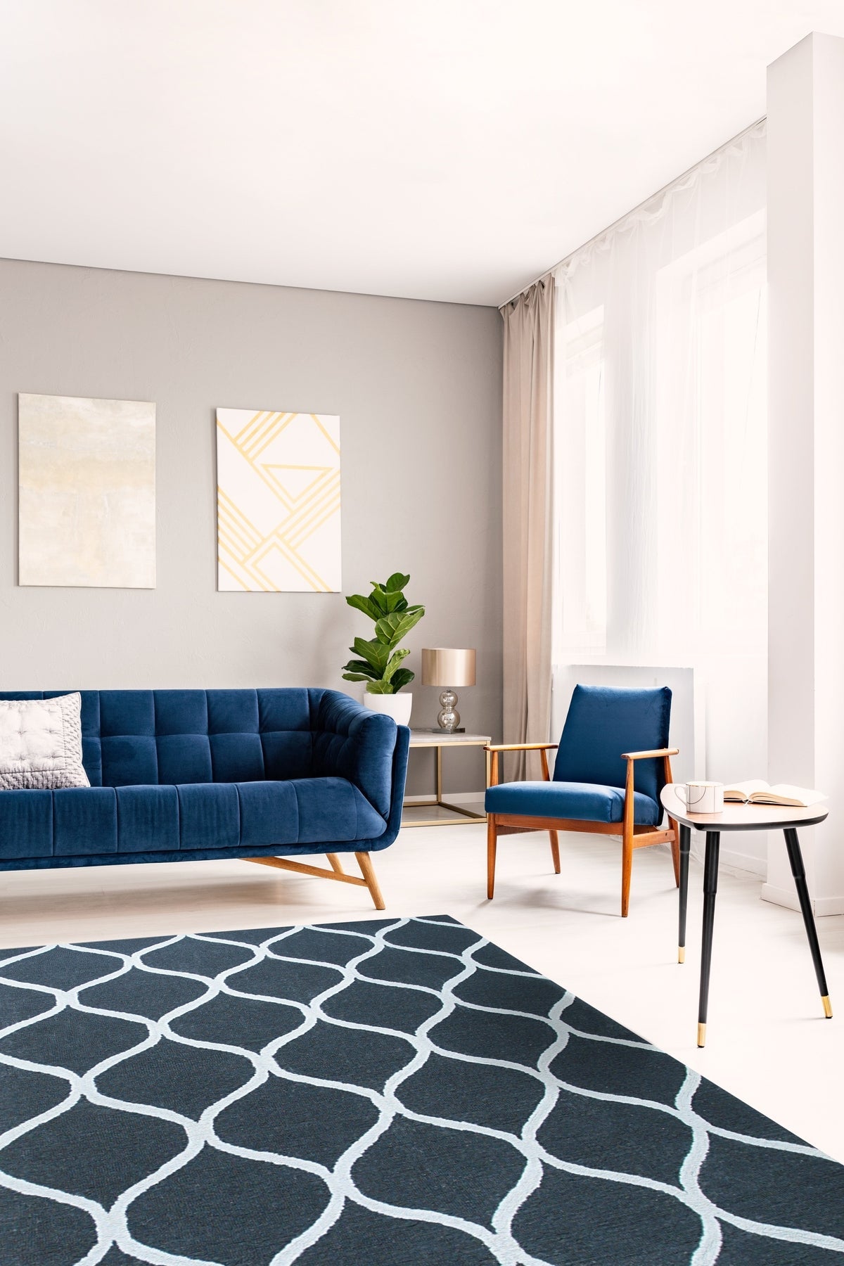 Beautiful Luna Black Hand Tufted Wool Rug, a deep charcoal wool rug with subtle, shimmering variations in tone, laid on a light hardwood floor, inviting warmth and texture to the space.