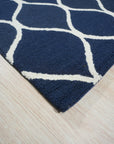 Jasmine Artisan Blue Hand Tufted Wool Rug, offering a textural landscape of deep blues and creamy whites in a modern geometric pattern, complements a light-filled living space with its soft wool pile and artisan-crafted feel.