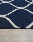 Jasmine Artisan Blue Hand Tufted Wool Rug displayed in a bright living room setting. Soft, blue hues blend across the hand-tufted wool pile, creating a calming and inviting space.