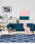 Jasmine Artisan Blue Hand Tufted Wool Rug gracing a warmly lit living space. Subtle textures and deep blues evoke a calming, artisan-crafted feel beneath furniture.