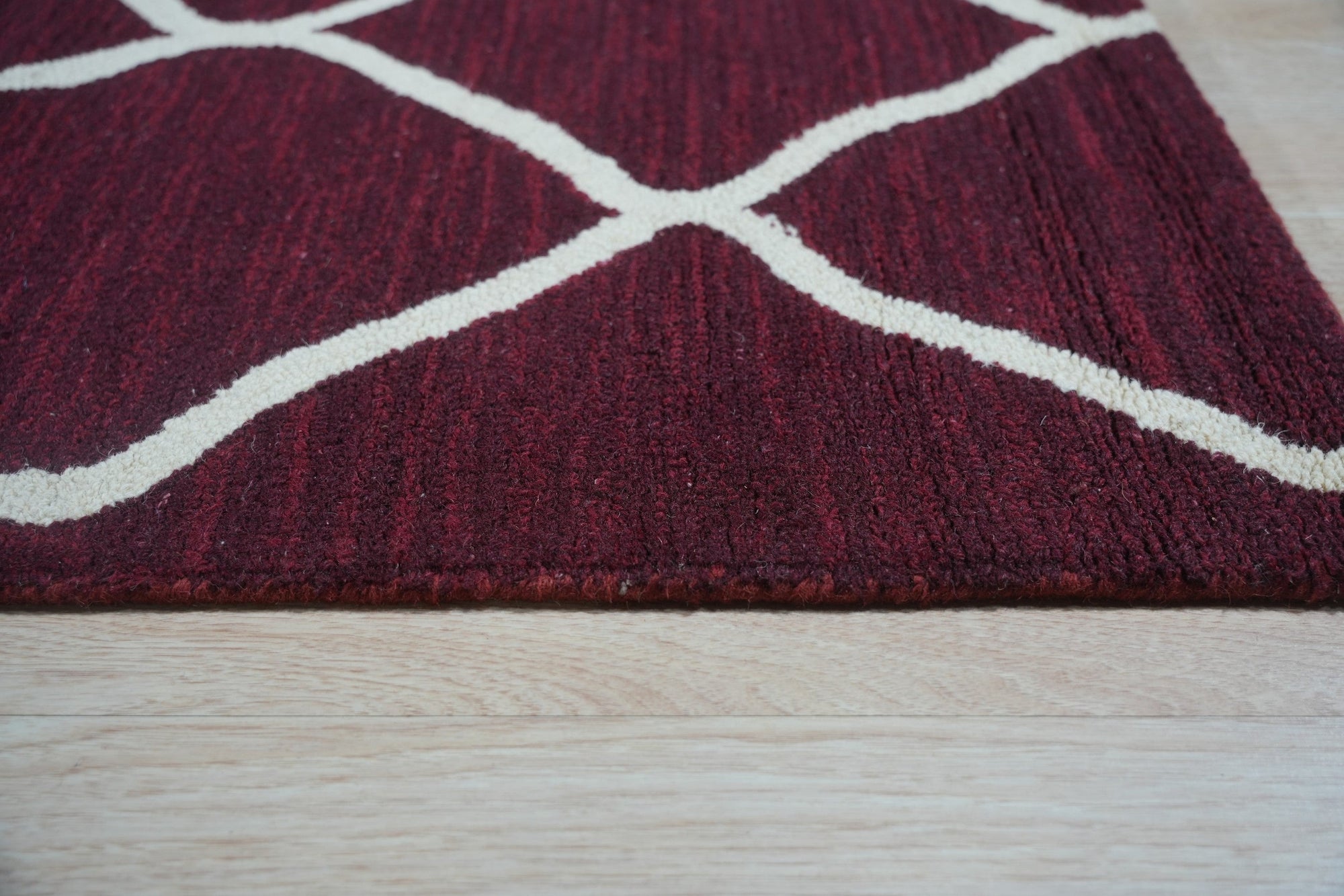 Timeless Louie Burgundy Hand Tufted Wool Rug, rich burgundy wool rug with a classic, intricate pattern, displayed in a room setting with complementing furniture.