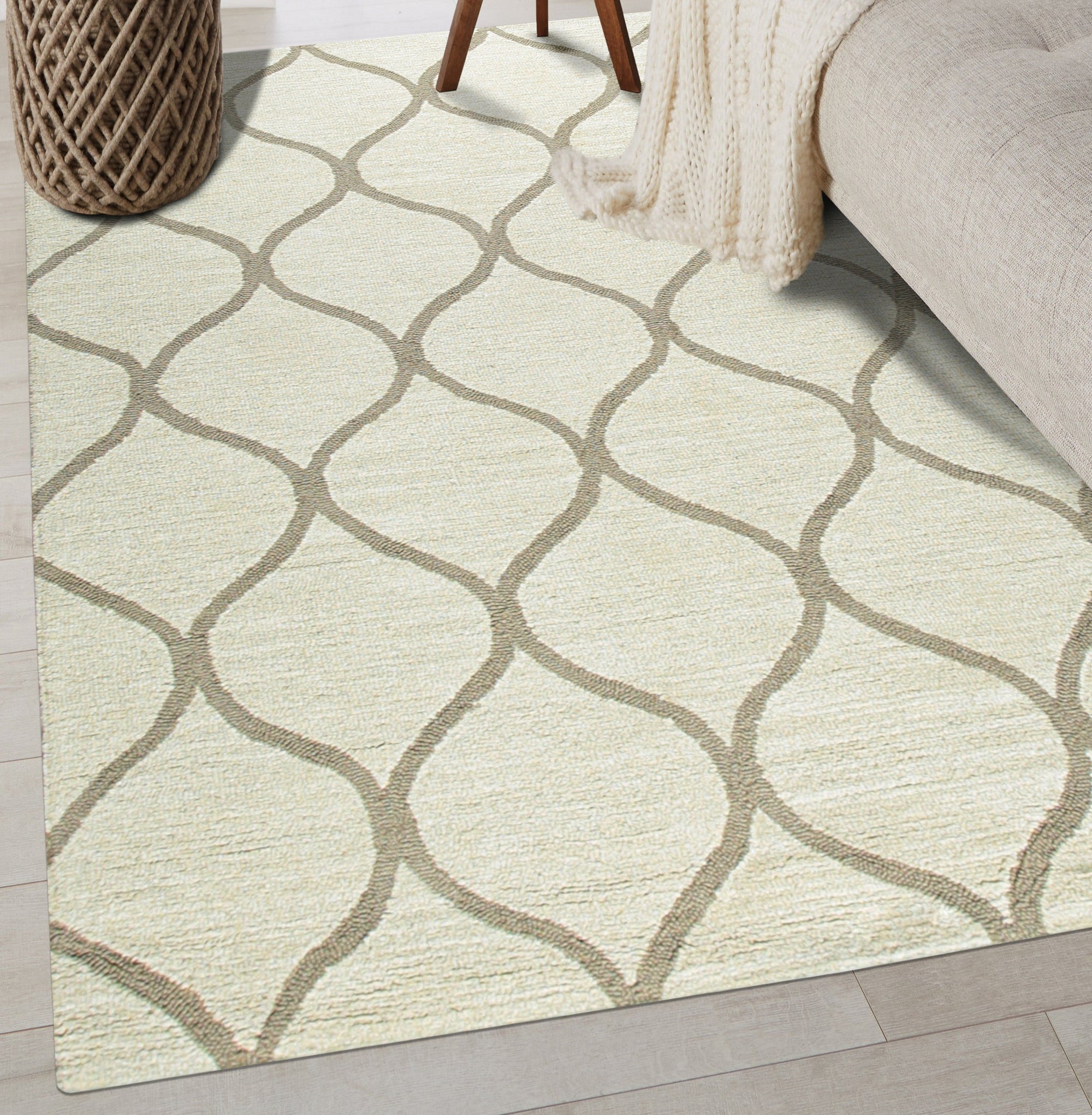 Zinnia Clara Light Gold Hand Tufted Wool Rug, its textured pile radiating warmth under soft light, complements a modern living room with neutral furniture.