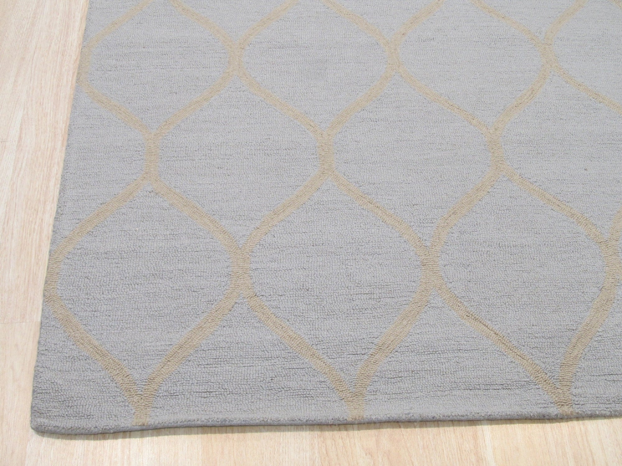 Tessa Chloe Light Blue Hand Tufted Wool Rug, a calming light blue wool rug with a subtle, textured pattern, softening a modern living space.
