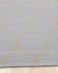 Tessa Chloe Light Blue Hand Tufted Wool Rug, a calming light blue wool rug with a subtle, textured pattern, softening a modern living space.